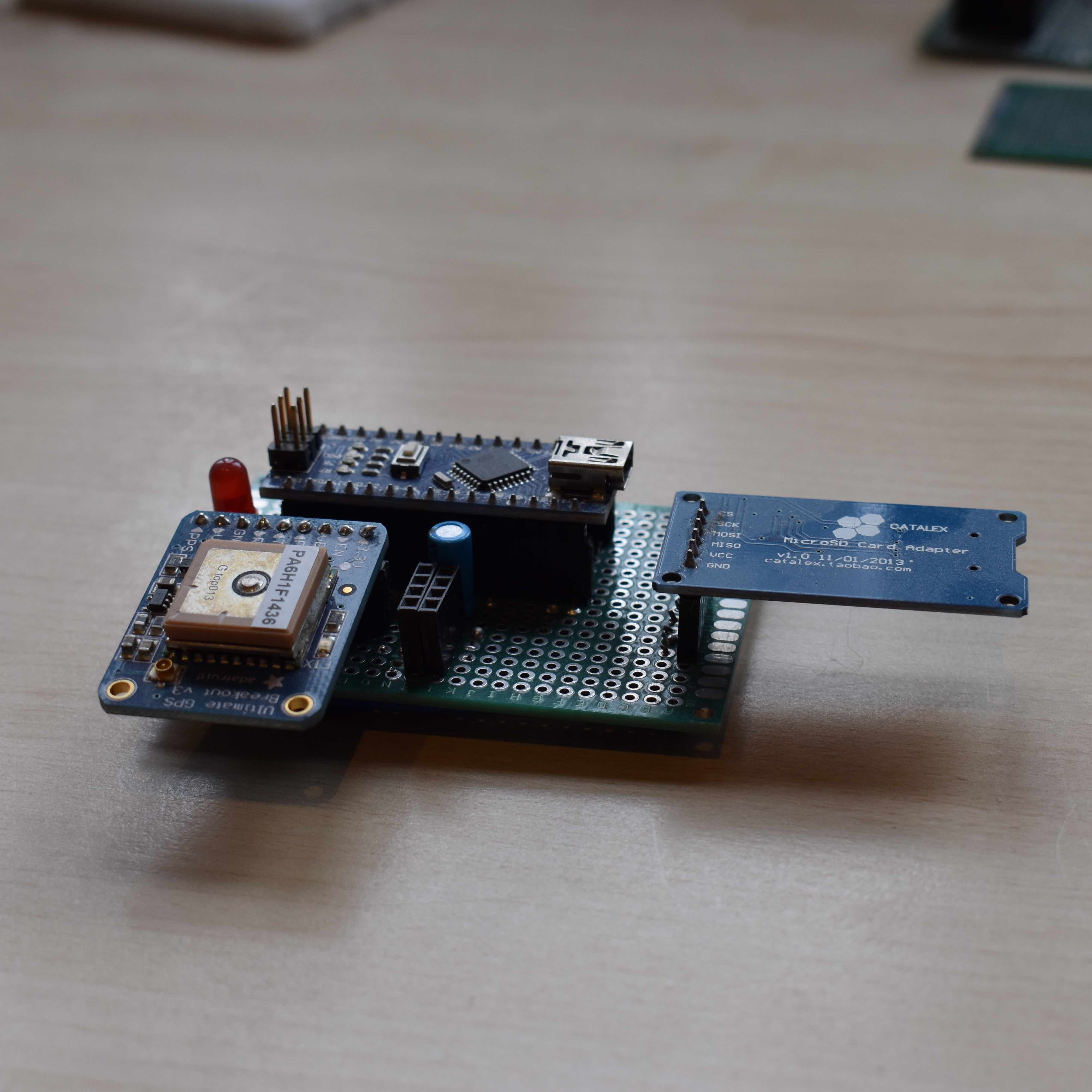 GPS module, SD card module and arduino soldered to a development board