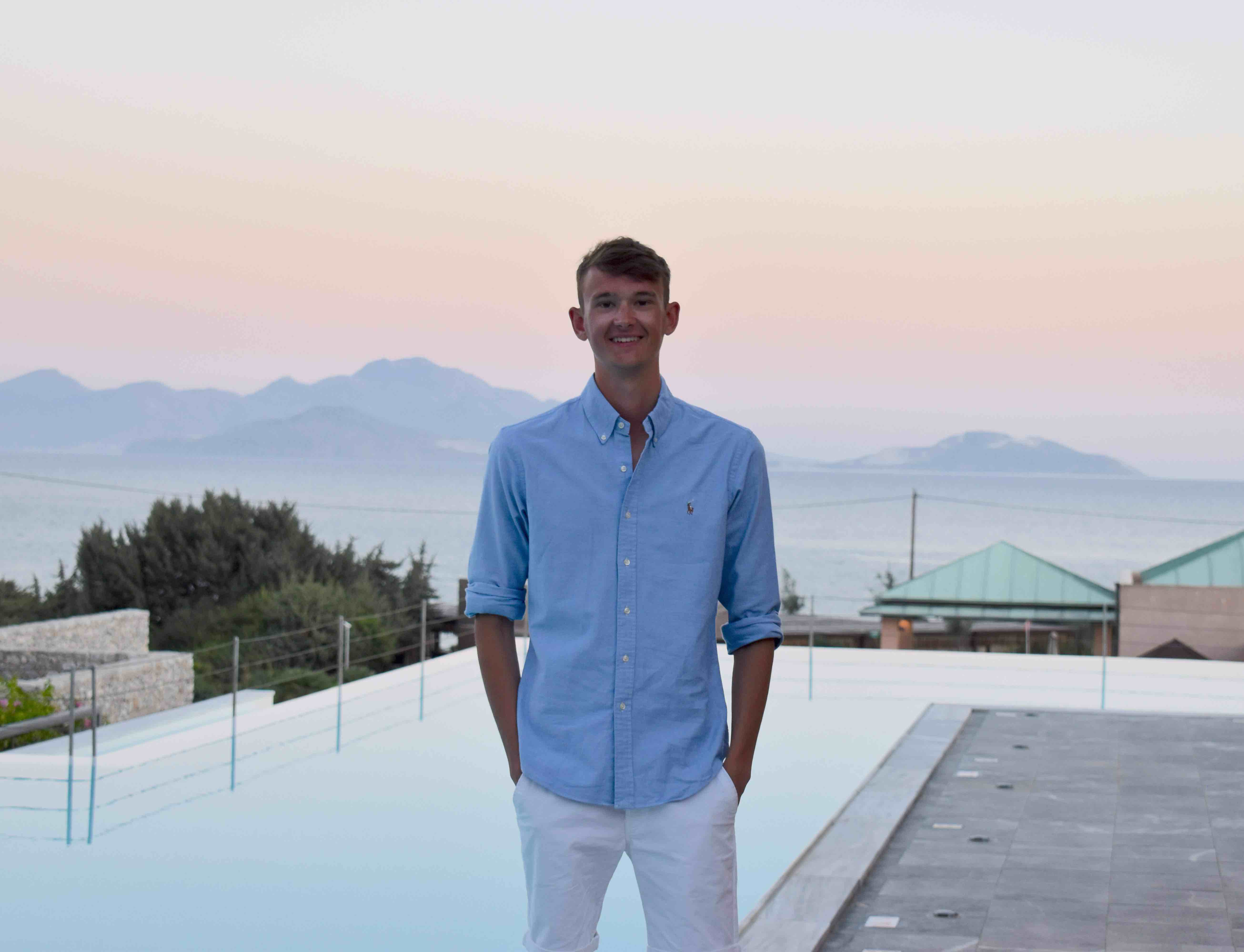 Matthew standing infront of scenic background