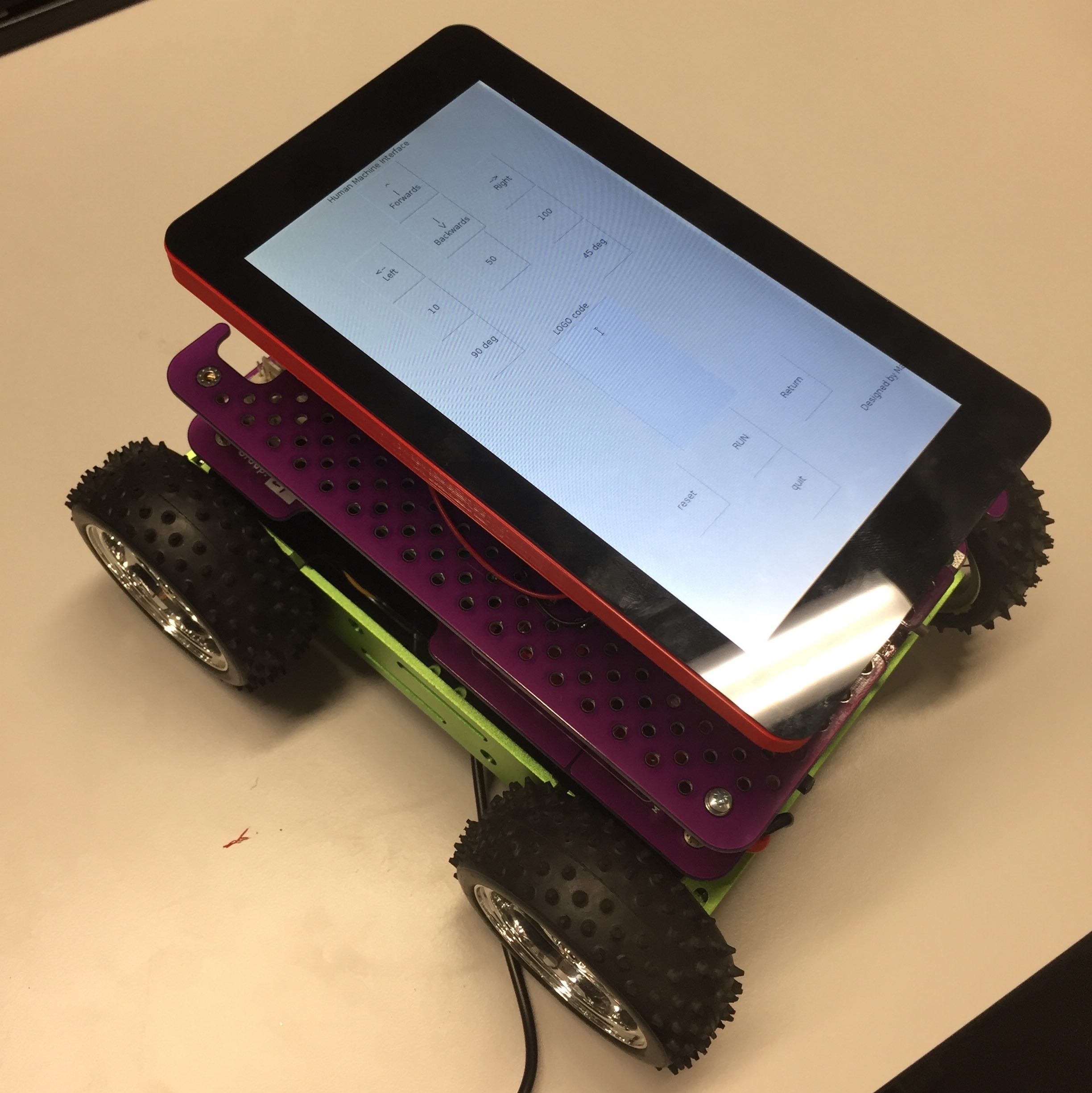 four wheeled Remote controlled car with a Raspberry Pi touchscreen attached to the top