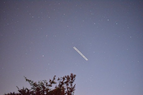 Starry Night Sky with a plane light trail